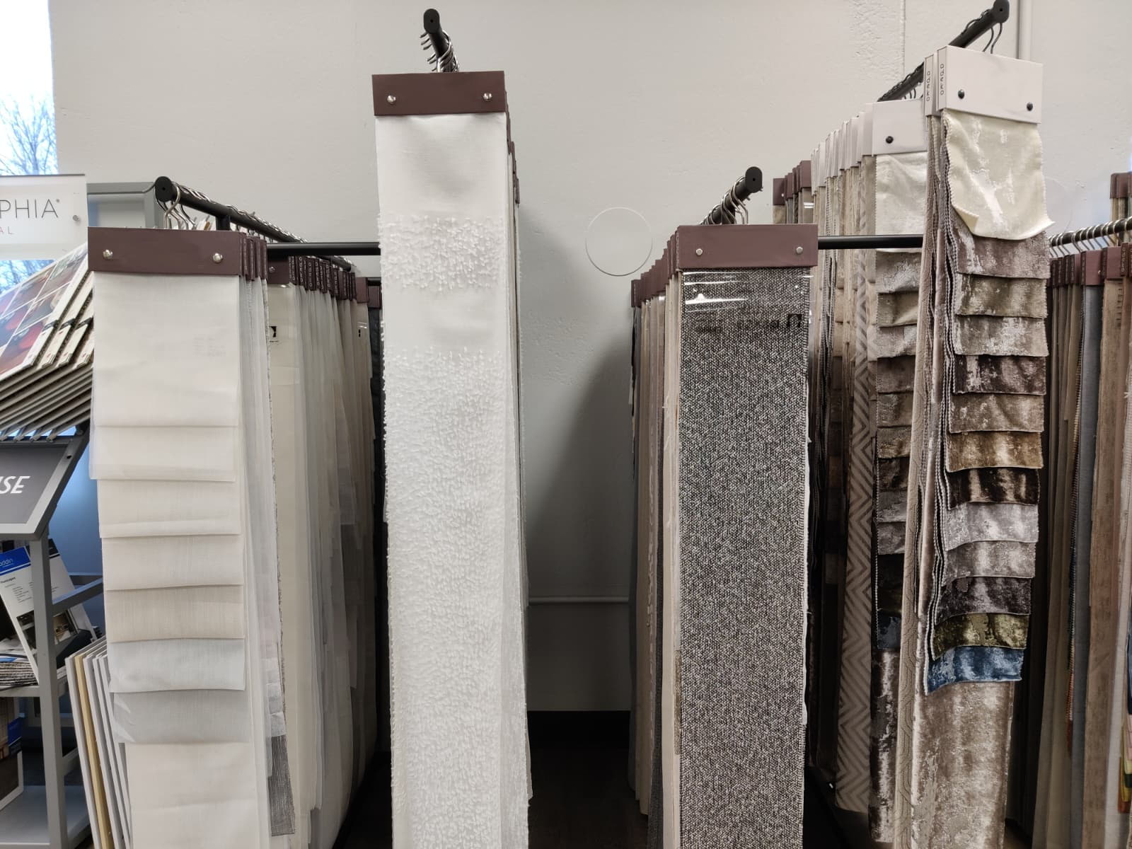 Custom drapery and sheer curtain panels on display racks